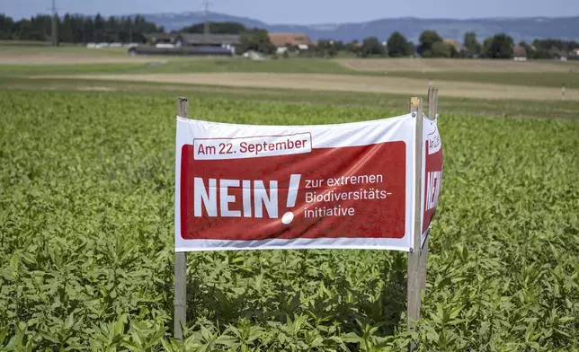 A poster for the No campaign ahead of a biodiversity referendum due to take place on Sept. 22, is seen in a field in Hoechstetten, Switzerland, Friday, Aug. 23, 2024, (Peter Schneider/Keystone via AP)