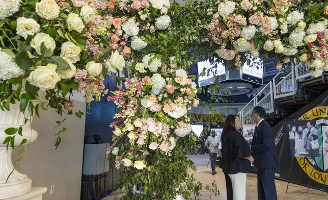 A wall of flowers by Hiram Smith of HiramStyle Flowers and Production greets family and guests entering Xavier University of Louisiana's convocation center for a Celebration of Life for Sybil Haydel Morial, Monday, Sept. 23, 2024, in New Orleans. (Chris Granger/The Times-Picayune/The New Orleans Advocate via AP)