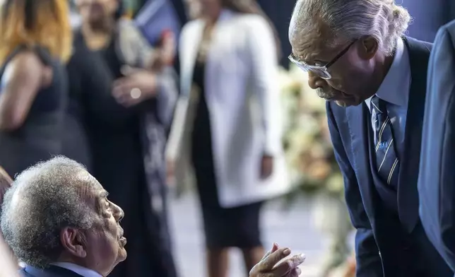 Former United States Ambassador to the United Nations Andrew Young Jr., bottom left, talks with Rev. Al Sharpton, right, founder and CEO of National Action Network, before the start of the Celebration of Life for Sybil Haydel Morial at Xavier University of Louisiana, Monday, Sept. 23, 2024, in New Orleans. (Chris Granger/The Times-Picayune/The New Orleans Advocate via AP)