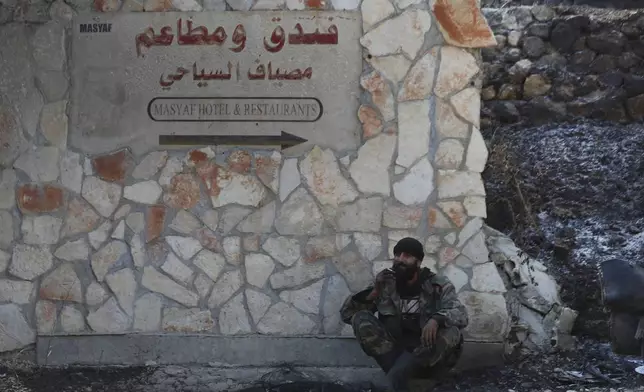 A Syrian soldier smokes a cigaret, as he sits on the ground in the town of Masyaf, Syria, Monday, Sept. 9, 2024. Syrian state news agency SANA says that Israeli strikes hit several areas in central Syria Sunday night, damaging a highway in Hama province and sparking fires. (AP Photo/Omar Sanadiki)