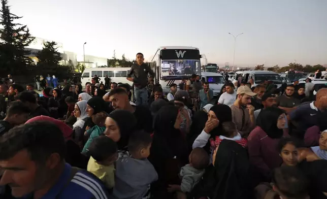 Syrians fleeing the war in Lebanon, arrive at the Syrian-Lebanese border crossing in Jdeidet Yabous, Syria, Wednesday, Sept. 25, 2024. (AP Photo/Omar Sanadiki)