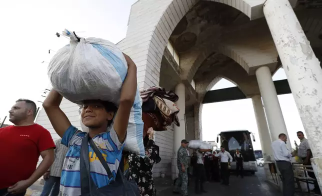 A Syrian boy fleeing the war in Lebanon with his family, arrives at the Syrian-Lebanese border crossing in Jdeidet Yabous, Syria, Wednesday, Sept. 25, 2024. (AP Photo/Omar Sanadiki)