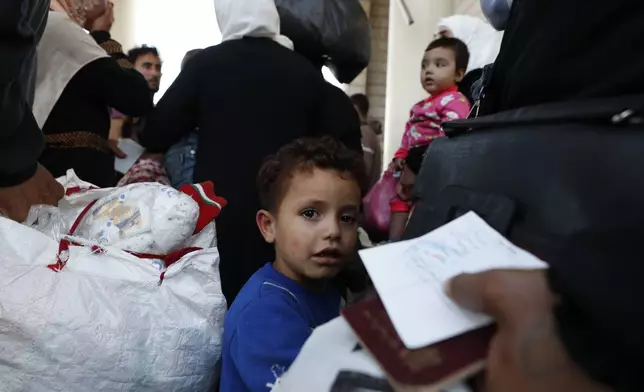 A Syrian boy fleeing the war in Lebanon with his family, arrives at the Syrian-Lebanese border crossing in Jdeidet Yabous, Syria, Wednesday, Sept. 25, 2024. (AP Photo/Omar Sanadiki)