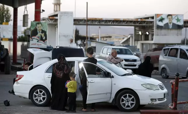 Lebanese fleeing the Israeli bombardment, arrive in a taxi at the Syrian-Lebanese border crossing in Jdaidet Yabous, Syria, Tuesday, Sept. 24, 2024. (AP Photo/Omar Sanadiki)