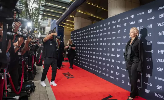 Pamela Anderson stands on the red carpet for the premiere of "The Last Showgirl" at the Princess of Wales Theatre, during the Toronto International Film Festival, in Toronto, Friday Sept. 6, 2024. (Paige Taylor White/The Canadian Press via AP)