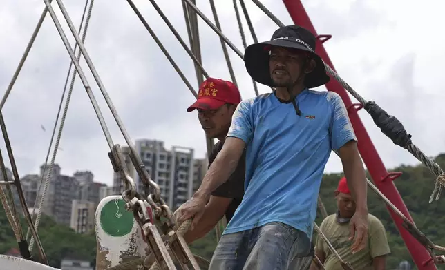 Workers tighten boats with ropes before Typhoon Krathon arrives, at a harbor in Keelung, Taiwan, Monday, Sept. 30, 2024. (AP Photo/Johnson Lai)