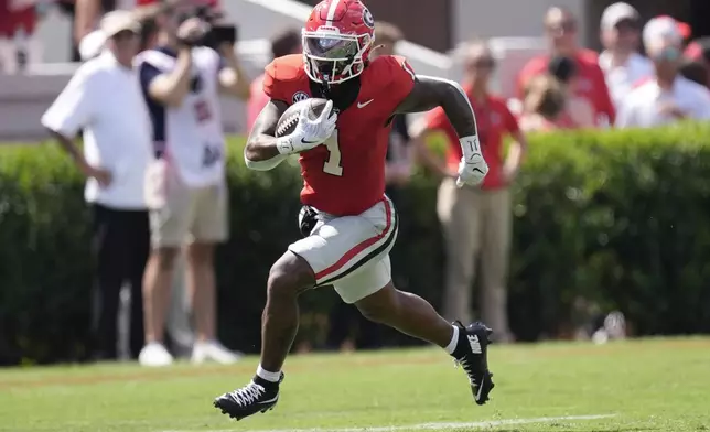 Georgia running back Trevor Etienne (1) runs for a big gain after a catch during the first half of an NCAA college football game against Tennessee Tech Saturday, Sept. 7, 2024, in Athens, Ga. (AP Photo/John Bazemore)