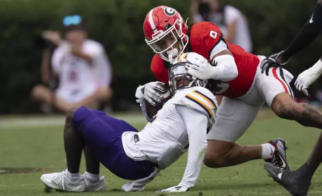 Georgia defensive back Justyn Rhett (9) is called for a face mask penalty as he tackles Tennessee Tech wide receiver Tremel Jones (2) during the second half of an NCAA college football game Saturday, Sept. 7, 2024, in Athens, Ga. (AP Photo/John Bazemore)