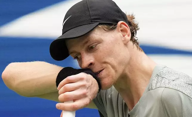 FILE - Jannik Sinner, of Italy, wipes sweat from his face between serves to Mackenzie McDonald, of the United States, during the first round of the U.S. Open tennis championships, Tuesday, Aug. 27, 2024, in New York. (AP Photo/Kirsty Wigglesworth, File)