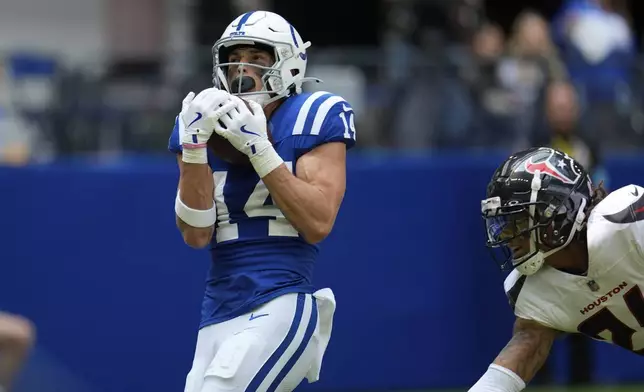 Indianapolis Colts wide receiver Alec Pierce (14) makes a touchdown reception during the first half of an NFL football game against the Houston Texans, Sunday, Sept. 8, 2024, in Indianapolis. (AP Photo/Michael Conroy)