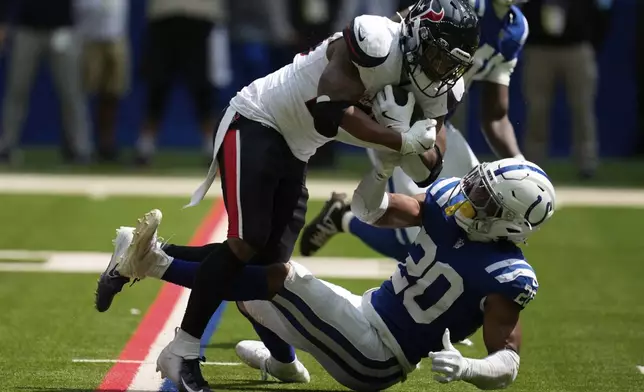 Houston Texans running back Joe Mixon (28) runs against Indianapolis Colts safety Nick Cross (20) during the first half of an NFL football game, Sunday, Sept. 8, 2024, in Indianapolis. (AP Photo/Darron Cummings)