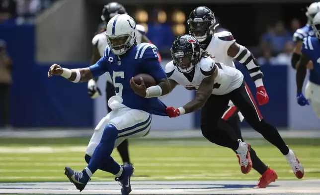 Indianapolis Colts quarterback Anthony Richardson (5) runs against Houston Texans cornerback Derek Stingley Jr. during the first half of an NFL football game, Sunday, Sept. 8, 2024, in Indianapolis. (AP Photo/Darron Cummings)