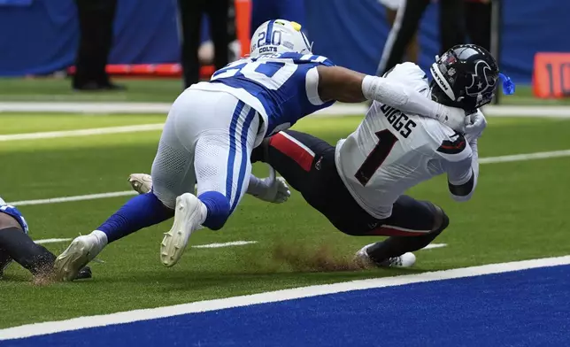 Houston Texans wide receiver Stefon Diggs (1) dives to the end zone against Indianapolis Colts safety Nick Cross (20) for a touchdown during the first half of an NFL football game, Sunday, Sept. 8, 2024, in Indianapolis. (AP Photo/Darron Cummings)