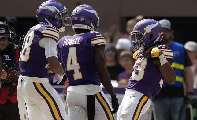 Minnesota Vikings running back Aaron Jones, right, celebrates with teammates after scoring a touchdown during the first half of an NFL football game against the Houston Texans, Sunday, Sept. 22, 2024, in Minneapolis. (AP Photo/Abbie Parr)