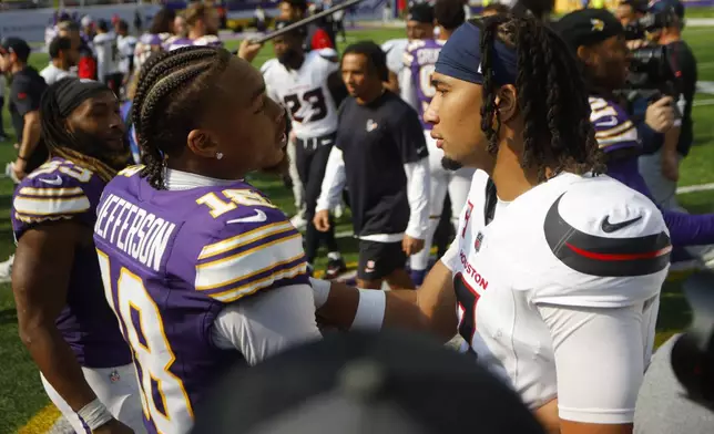 Minnesota Vikings wide receiver Justin Jefferson (18) talks with Houston Texans quarterback C.J. Stroud (7) after an NFL football game, Sunday, Sept. 22, 2024, in Minneapolis. The Vikings won 34-7. (AP Photo/Bruce Kluckhohn)