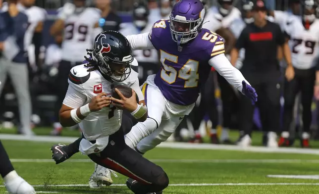 Houston Texans quarterback C.J. Stroud (7) slides to the turf in front of Minnesota Vikings linebacker Kamu Grugier-Hill (54) during the first half of an NFL football game, Sunday, Sept. 22, 2024, in Minneapolis. (AP Photo/Bruce Kluckhohn)