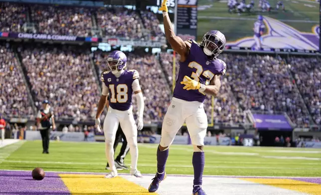 Minnesota Vikings running back Aaron Jones (33) celebrates after a 39-yard run during the second half of an NFL football game against the Houston Texans, Sunday, Sept. 22, 2024, in Minneapolis. (AP Photo/Abbie Parr)