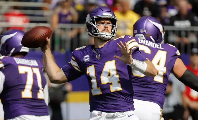 Minnesota Vikings quarterback Sam Darnold (14) throws a pass during the first half of an NFL football game against the Houston Texans, Sunday, Sept. 22, 2024, in Minneapolis. (AP Photo/Bruce Kluckhohn)