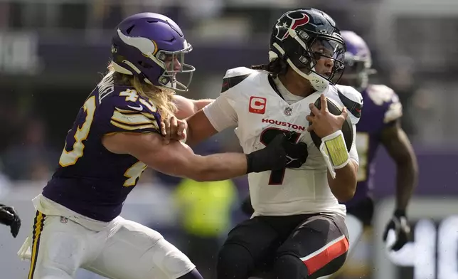 Houston Texans quarterback C.J. Stroud (7) is tackled by Minnesota Vikings linebacker Andrew Van Ginkel (43) during the first half of an NFL football game, Sunday, Sept. 22, 2024, in Minneapolis. (AP Photo/Abbie Parr)