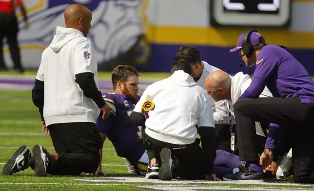 Minnesota Vikings quarterback Sam Darnold sits on the field after getting injured during the second half of an NFL football game against the Houston Texans, Sunday, Sept. 22, 2024, in Minneapolis. (AP Photo/Bruce Kluckhohn)