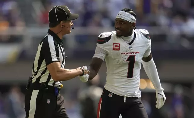 Houston Texans wide receiver Stefon Diggs (1) talks with an official while walking to the locker room at halftime of an NFL football game against the Minnesota Vikings, Sunday, Sept. 22, 2024, in Minneapolis. (AP Photo/Abbie Parr)