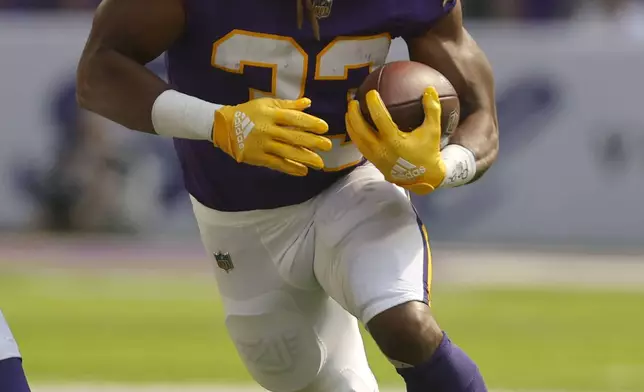 Minnesota Vikings running back Aaron Jones (33) carries the ball up field during the first half of an NFL football game against the Houston Texans, Sunday, Sept. 22, 2024, in Minneapolis. (AP Photo/Bruce Kluckhohn)