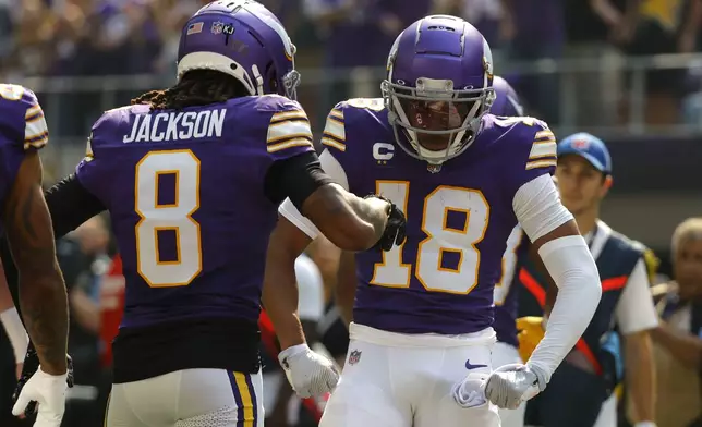 Minnesota Vikings wide receiver Justin Jefferson (18) celebrates after catching a touchdown pass during the first half of an NFL football game against the Houston Texans, Sunday, Sept. 22, 2024, in Minneapolis. (AP Photo/Bruce Kluckhohn)