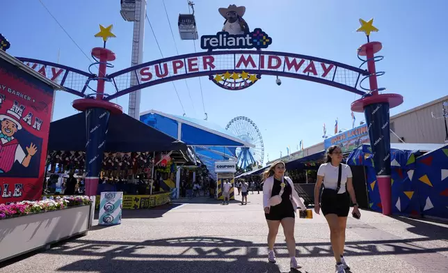 Guests make their way through the Super Midway at the State Fair of Texas in Dallas on Friday, Sept. 27, 2024. (AP Photo/Tony Gutierrez)