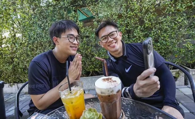 Kunchanok khantiphong, 27, speaks with a family member of his Filipino partner Edward Jonathan Caiga, 42, in Bangkok, Thailand, Saturday, July 6, 2024. (AP Photo/Sakchai Lalit)