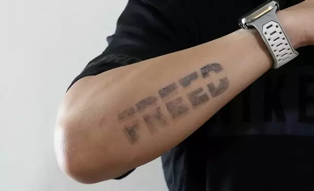 Edward Jonathan Caiga, 42, displays a tattoo on his arm in Bangkok, Thailand, Sunday, July 14, 2024, (AP Photo/Sakchai Lalit)