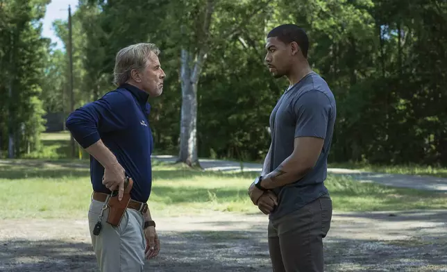 This image released by Netflix shows Don Johnson as Chief Sandy Burnne, left, and Aaron Pierre as Terry Richmond in a scene from "Rebel Ridge." (Allyson Riggs/Netflix via AP)