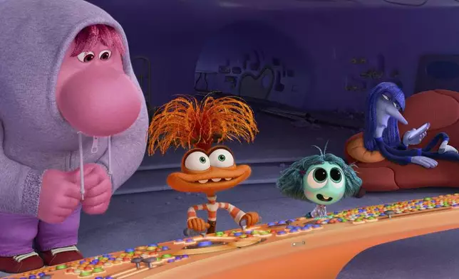 This image released by Disney/Pixar shows, from left, Embarrassment, voiced by Paul Walter Hauser, Anxiety, voiced by Maya Hawke, Envy, voiced by Ayo Edebiri, and Ennui, voiced by Adèle Exarchopoulos in a scene from "Inside Out 2." (Disney/Pixar via AP)