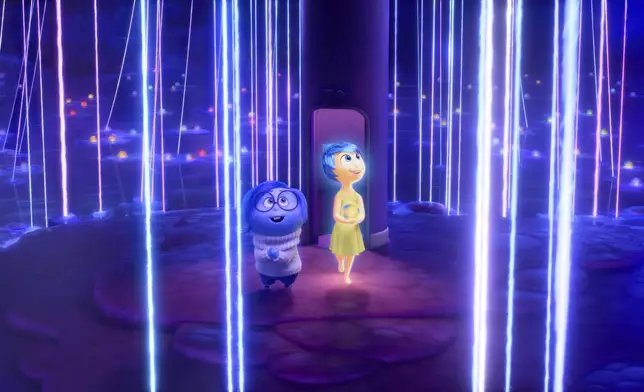 This image released by Disney/Pixar shows, from left, Sadness, voiced by Phyllis Smith, left, and Joy, voiced by Amy Poehler, in a scene from "Inside Out 2." (Disney/Pixar via AP)