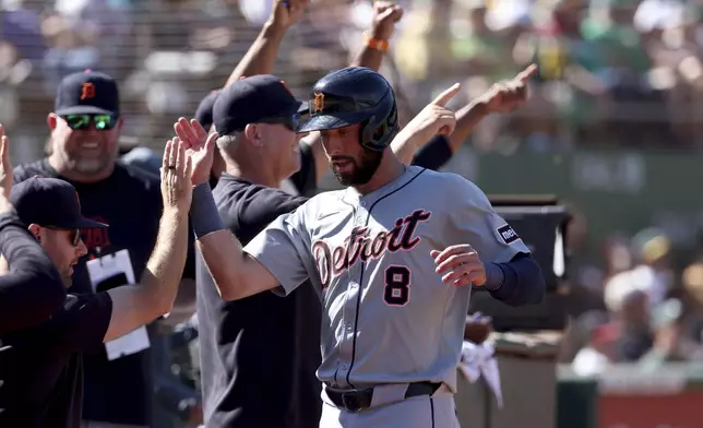 Detroit Tigers' Matt Vierling (8) celebrates after scoring on an RBI single by Riley Greene during the eighth inning of a baseball game against the Oakland Athletics in Oakland, Calif., Sunday, Sept. 8, 2024. (AP Photo/Jed Jacobsohn)