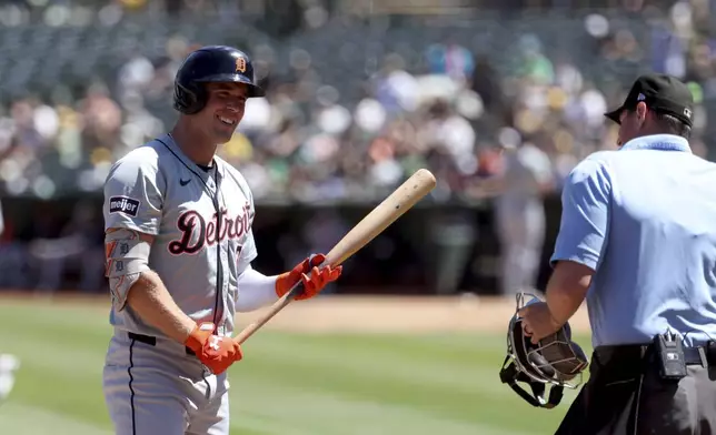 Detroit Tigers' Kerry Carpenter, left, argues with home plate umpire Quinn Wolcott, right, after striking out during the first inning of a baseball game against the Oakland Athletics in Oakland, Calif., Sunday, Sept. 8, 2024. (AP Photo/Jed Jacobsohn)