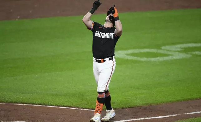 Baltimore Orioles' James McCann celebrates after his two-run home run during the fourth inning of a baseball game against the Detroit Tigers, Friday, Sept. 20, 2024, in Baltimore. (AP Photo/Nick Wass)