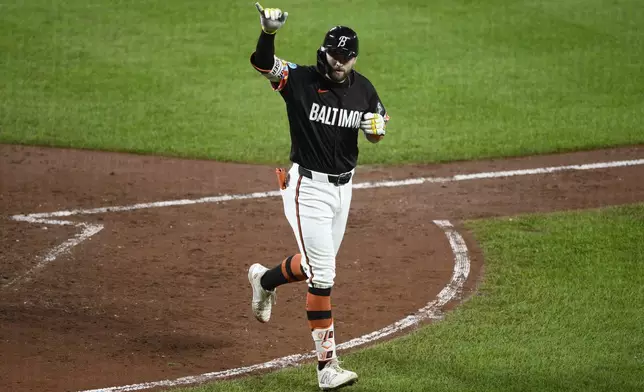 Baltimore Orioles' Colton Cowser celebrates his home run during the sixth inning of a baseball game against the Detroit Tigers, Friday, Sept. 20, 2024, in Baltimore. (AP Photo/Nick Wass)