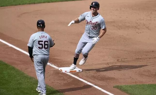 Detroit Tigers' Kerry Carpenter (30) reacts as he rounds third base on his home run next to third base coach Joey Cora (56) during the sixth inning of a baseball game against the Baltimore Orioles, Sunday, Sept. 22, 2024, in Baltimore. (AP Photo/Nick Wass)