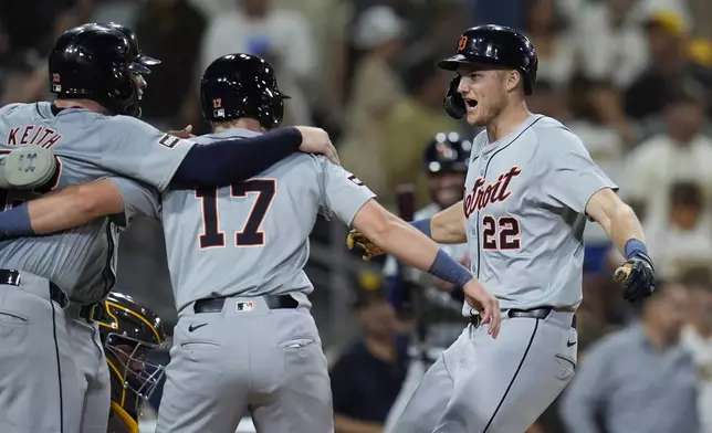 Detroit Tigers' Parker Meadows, right, celebrates with teammates Jace Jung, center, and Colt Keith, left, after hitting a grand slam during the ninth inning of a baseball game against the San Diego Padres, Thursday, Sept. 5, 2024, in San Diego. (AP Photo/Gregory Bull)