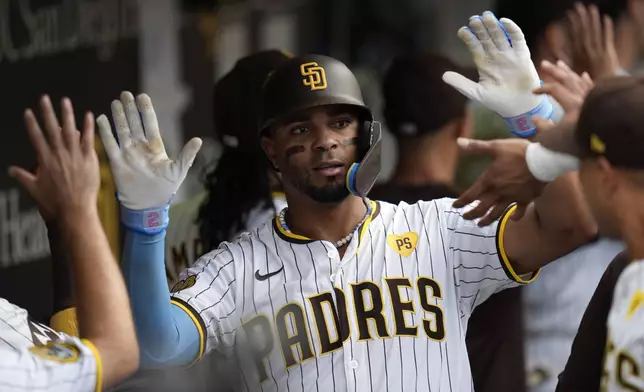 San Diego Padres' Xander Bogaerts celebrates with teammates after hitting a two-run home run during the second inning of a baseball game against the Detroit Tigers, Thursday, Sept. 5, 2024, in San Diego. (AP Photo/Gregory Bull)