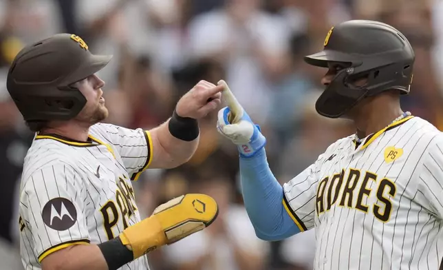 San Diego Padres' Xander Bogaerts, right, celebrates with teammate Jake Cronenworth after hitting a two-run home run during the second inning of a baseball game against the Detroit Tigers, Thursday, Sept. 5, 2024, in San Diego. (AP Photo/Gregory Bull)