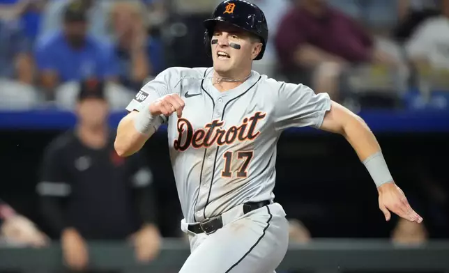 Detroit Tigers' Jace Jung runs home to score on a double by Trey Sweeney during the third inning of a baseball game against the Kansas City Royals Wednesday, Sept. 18, 2024, in Kansas City, Mo. (AP Photo/Charlie Riedel)