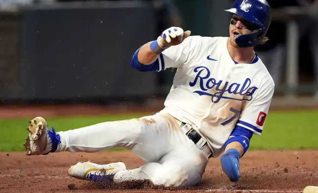 Kansas City Royals' Bobby Witt Jr. slides home to score on a single by Michael Massey during the third inning of a baseball game against the Detroit Tigers Tuesday, Sept. 17, 2024, in Kansas City, Mo. (AP Photo/Charlie Riedel)