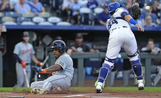 Detroit Tigers' Andy Ibanez beats the tag by Kansas City Royals catcher Freddy Fermin (34) to score on a double by Matt Vierling during the first inning of a baseball game Tuesday, Sept. 17, 2024, in Kansas City, Mo. (AP Photo/Charlie Riedel)