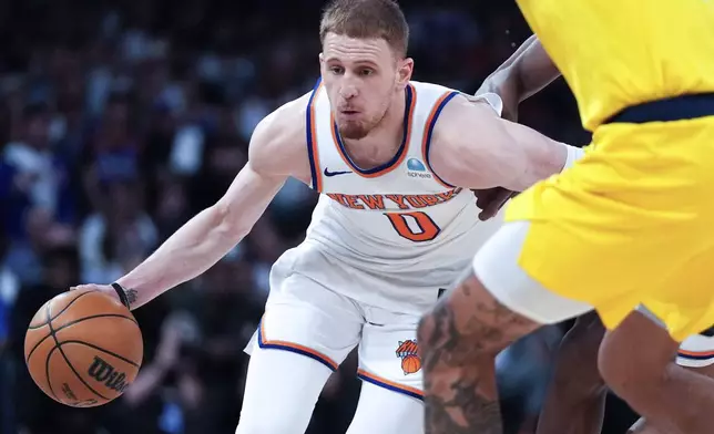 FILE - New York Knicks guard Donte DiVincenzo (0) dribbles during the second half of Game 7 in an NBA basketball second-round playoff series against the Indiana Pacers, on May 19, 2024, in New York. (AP Photo/Julia Nikhinson, File)