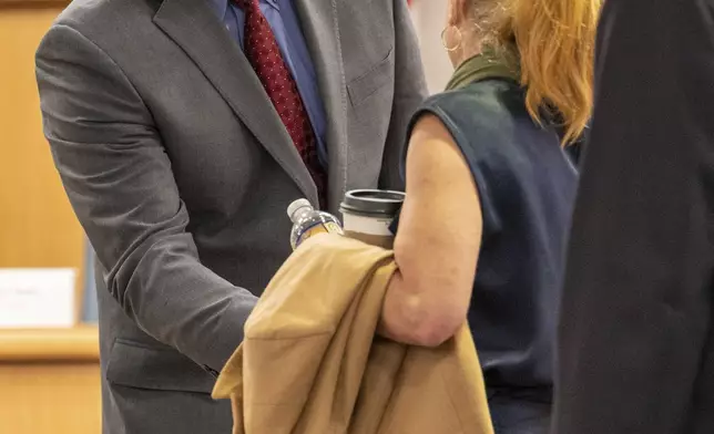 Jason Neubauer, Board Chairman speaks with Amber Bay, Former OceanGate Director of Administration after her testimony at the Titan marine board of investigation hearing inside the Charleston County Council Chambers Tuesday, Sept. 24, 2024, in North Charleston, S.C. (Corey Connor via AP, Pool)