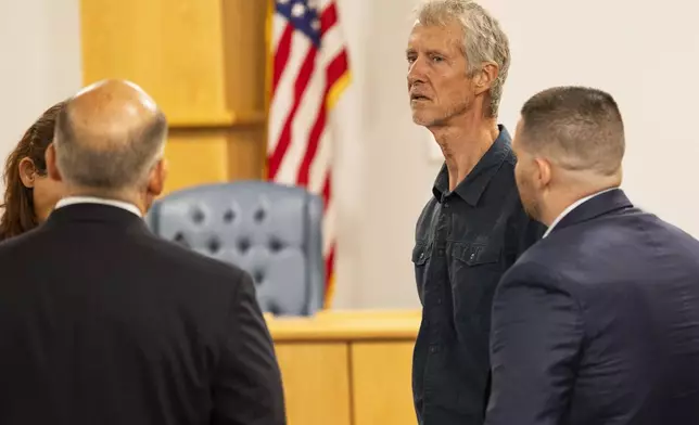 Tym Catterson, second from right, a contractor for OceanGate, talks to family members from the Titan tragedy after his testimony ended in a Coast Guard investigatory hearing on the causes of the implosion of an experimental submersible headed for the wreck of the Titanic, Monday, Sept. 16, 2024, in North Charleston, S.C. (AP Photo/Mic Smith)