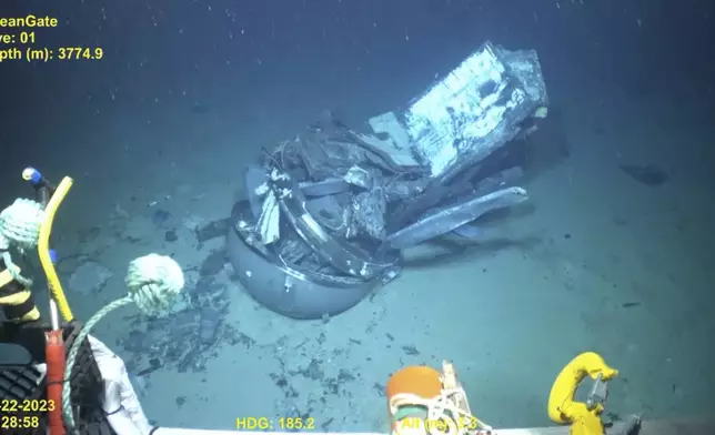 This June 2023 United States Coast Guard still frame from video provided by Pelagic Research Services, shows remains of the Titan submersible, center, on the floor of the Atlantic Ocean. (U.S. Coast Guard Video courtesy Pelagic Research Services via AP)