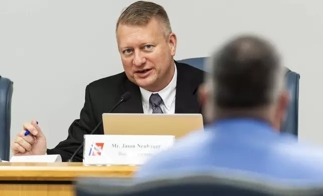 Jason Neubauer, at left, board chairman, questions Matthew McCoy, a former OceanGate employee, during the final day of the Coast Guard investigatory hearing on the causes of the implosion of an experimental submersible headed for the wreck of the Titanic, Friday, Sept. 27, 2024, in North Charleston, S.C. (AP Photo/Mic Smith)