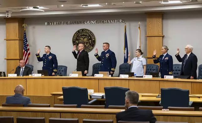 Coast Guard members of the investigative board for the Titan marine board formal hearing take an oath inside the Charleston County Council Chambers Monday, Sept. 16, 2024, in North Charleston, S.C. (AP Photo/Mic Smith)